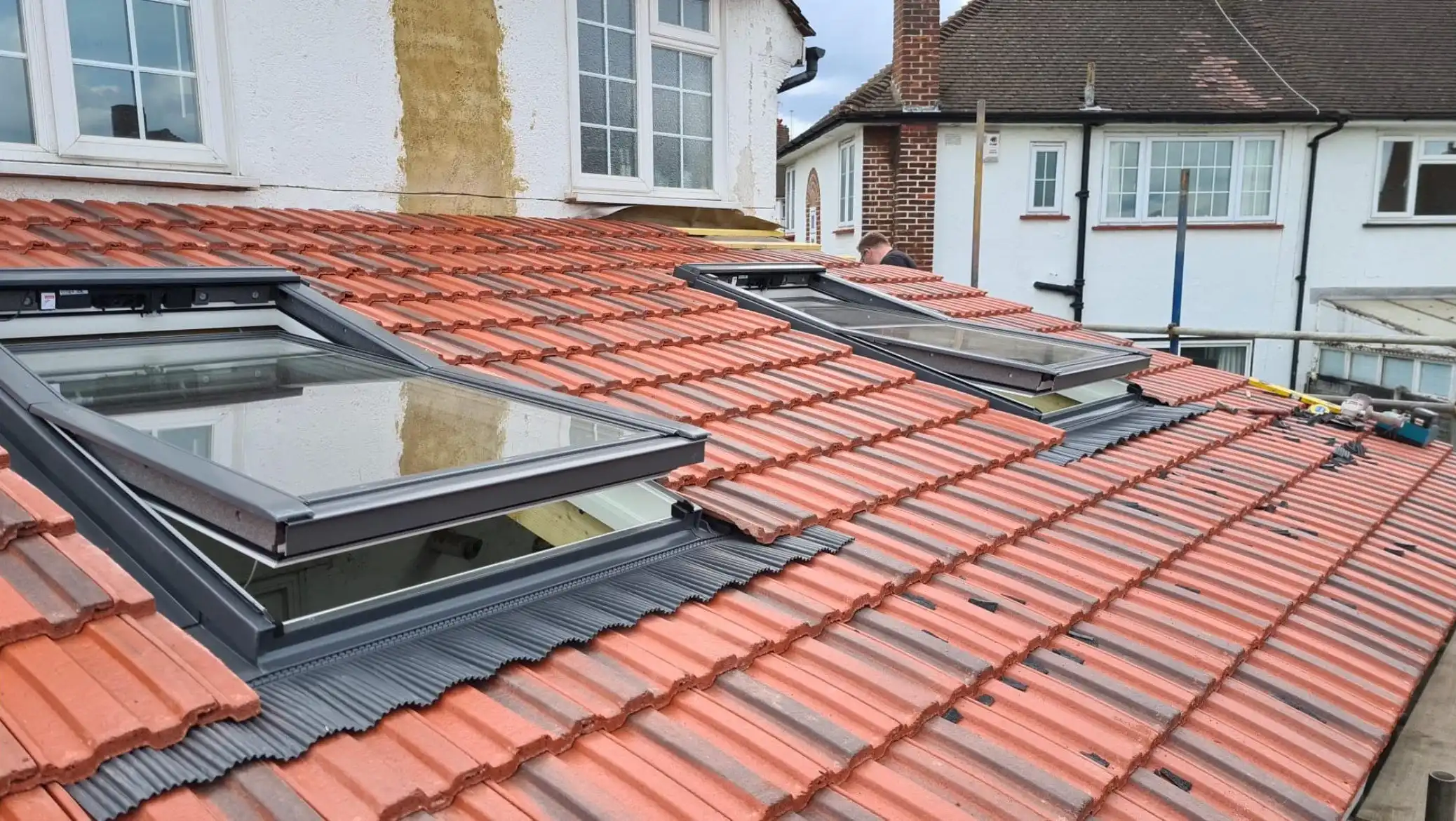 red roofing with velux windows.
